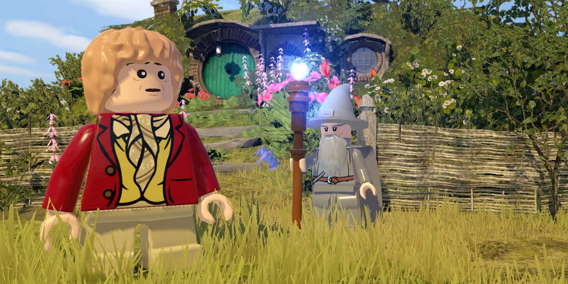 Lego Bilbo Baggins stands in front of his house looking concerned as Lego Gandalf stands near him with his staff glowing