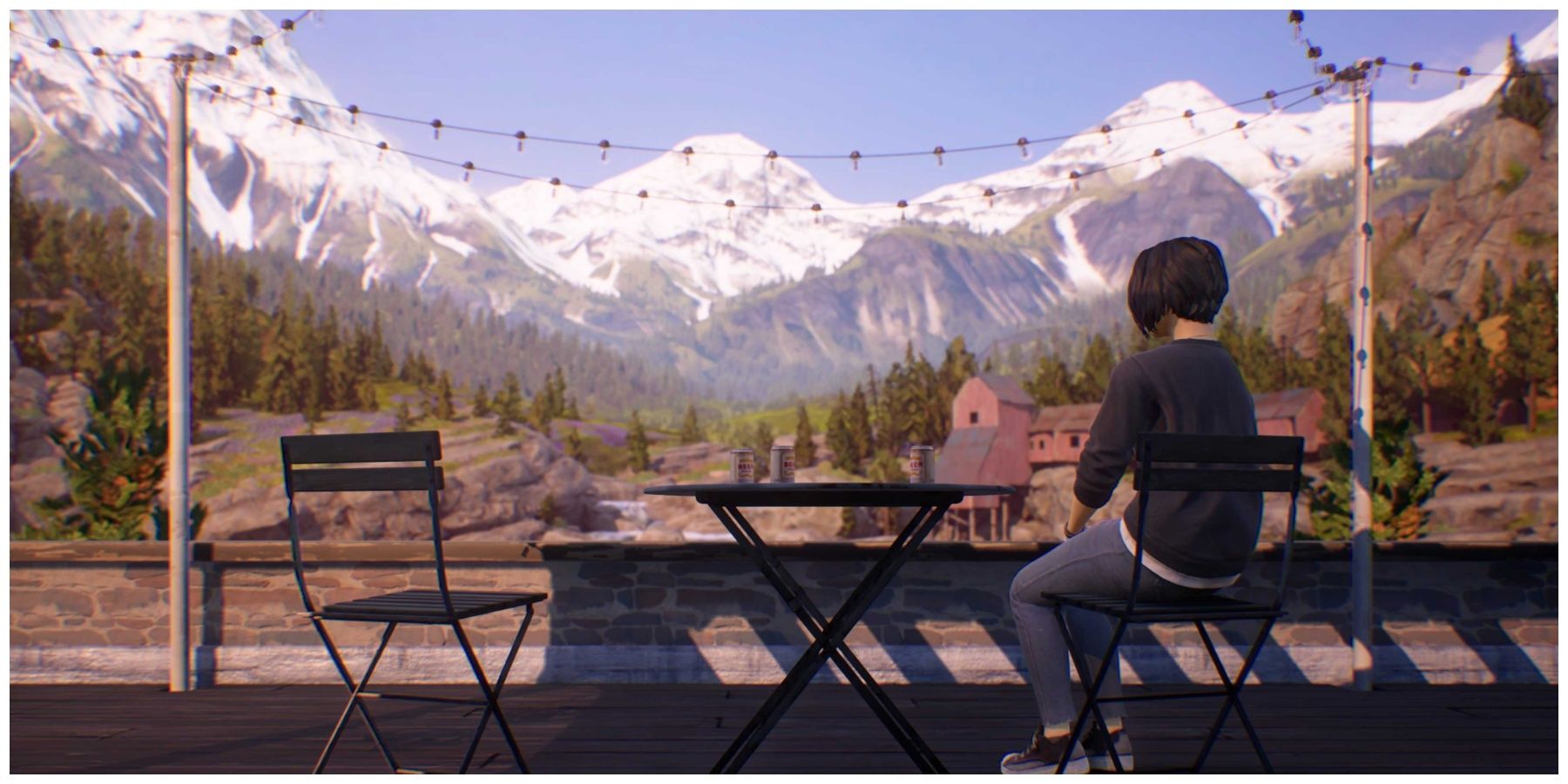 A girl sits alone looking out at a mountain