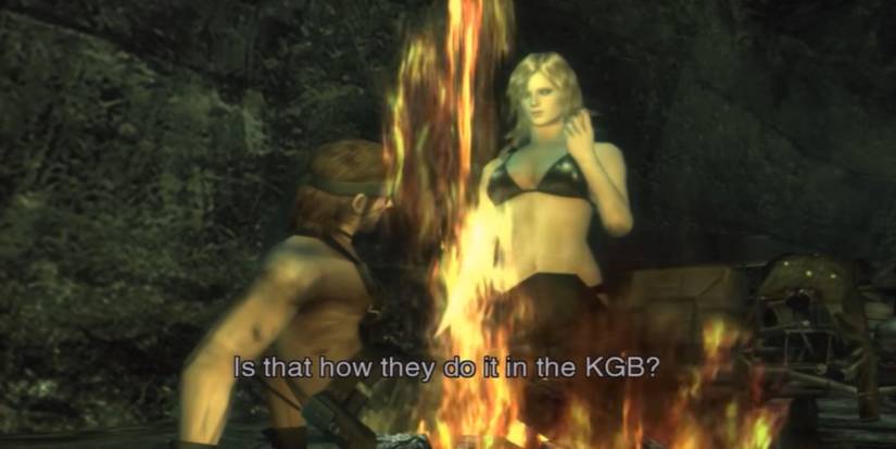 Naked Snake and EVA holding a Transmitter near a fireplace in a cave