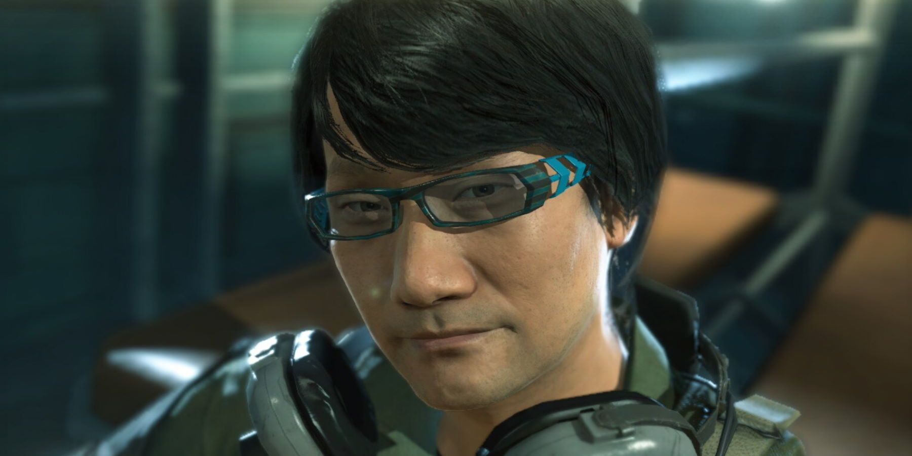 Hideo Kojima wearing headphone and smiling at the camera in a helicopter-1