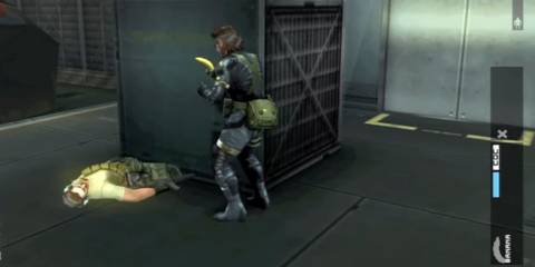 Big Boss standing over a knocked-out soldier in a hangar, banana in-hand