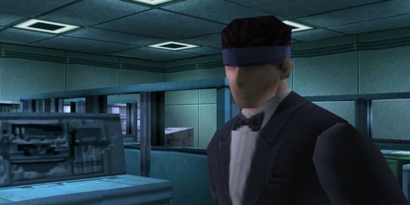 Solid Snake in a computer room dressed in a bandana and tuxedo