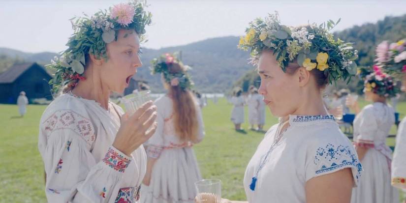 An image of a woman in shock while having a conversation with Dani in Midsommar