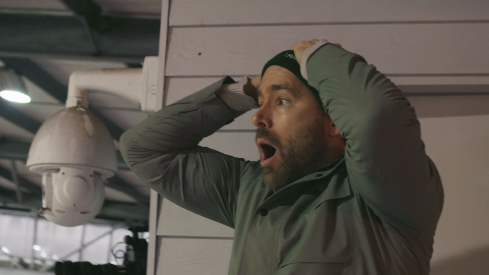 Ryan Reynolds in shock with hands above head in Wrexham stands