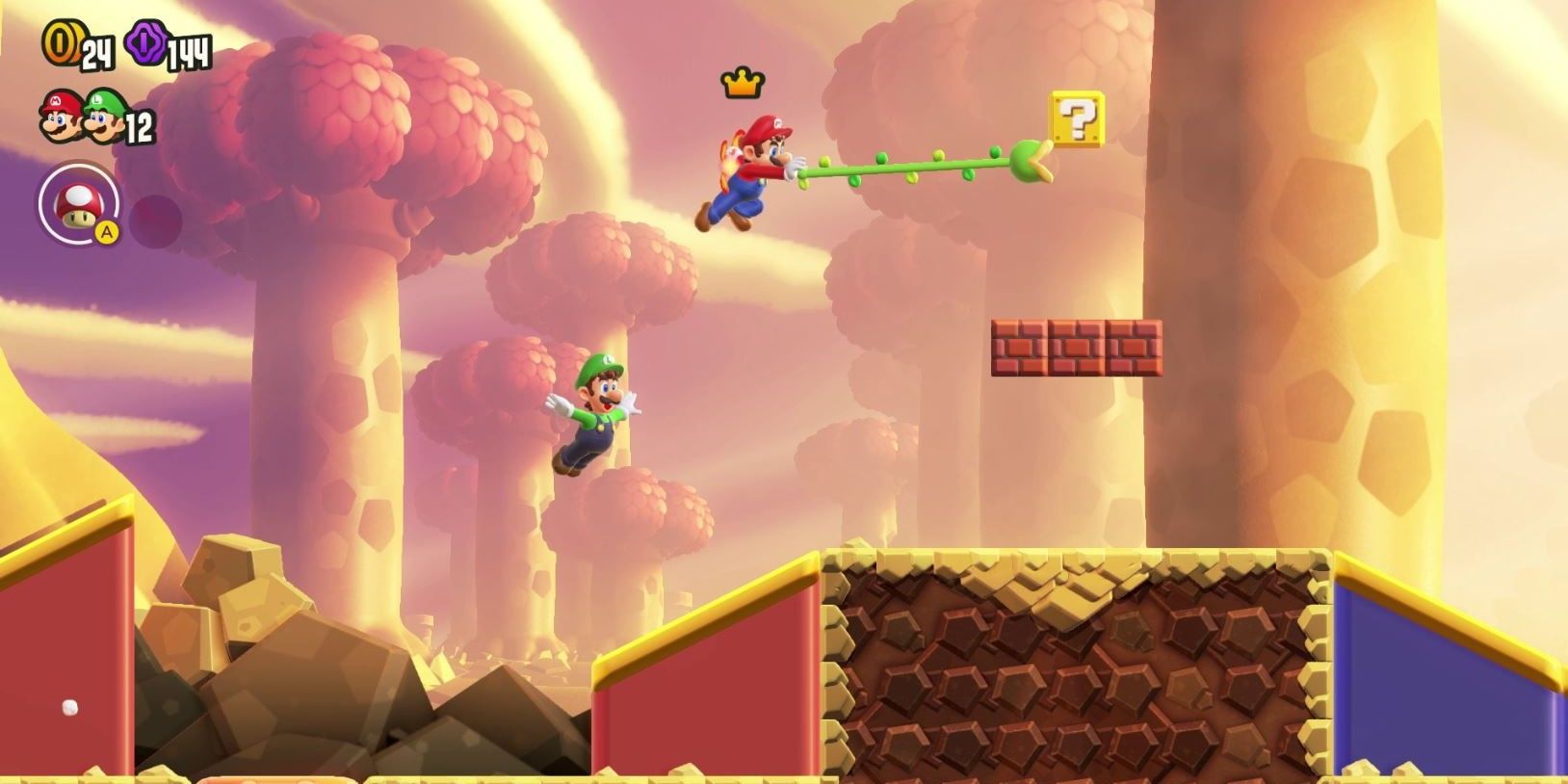 Mario grappling to a "?" Block while Luigi leaps below him in Super Mario Bros Wonder
