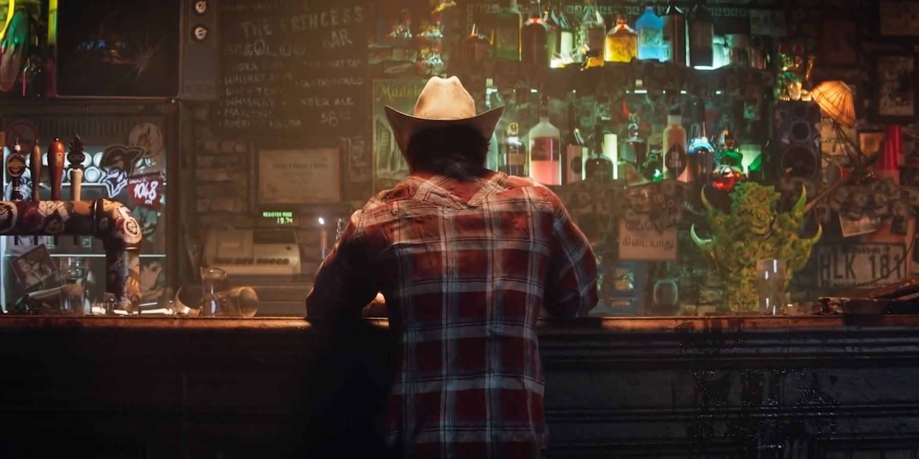 Wolvering sitting at a bar in a cowboy hat