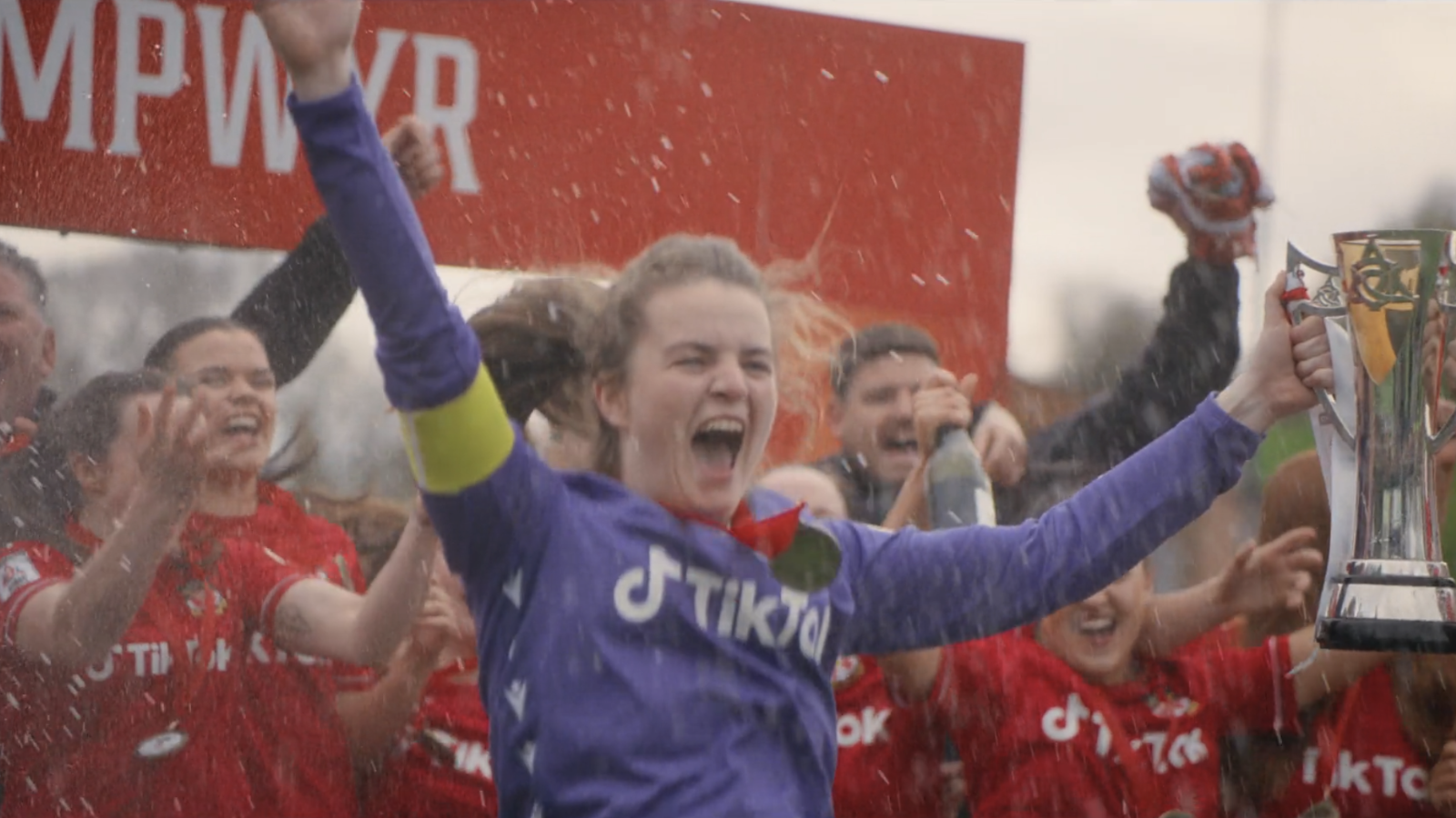 Wrexham AFC goalkeeper Del Morgan celebrating league promotion with team.