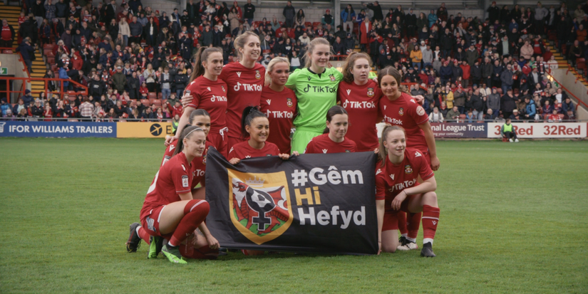 Wrexham's women's team posing for photo in the Racecourse Ground.