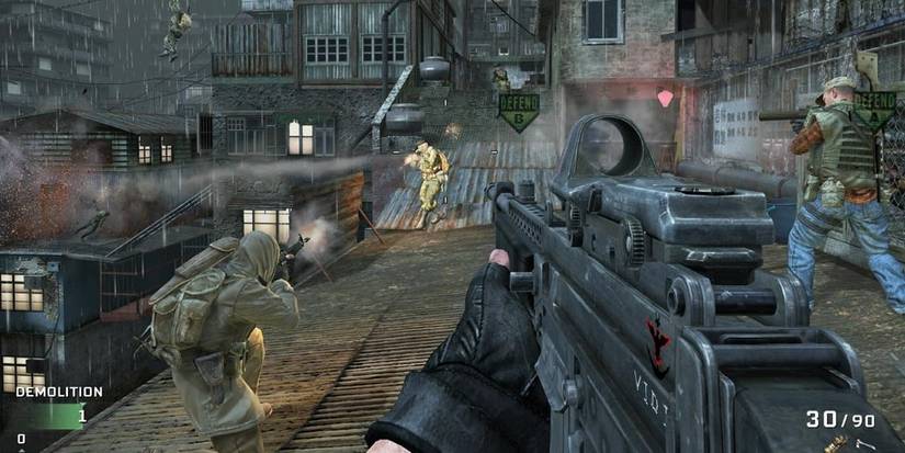 Three soldiers firing at an enemy on a rooftop 