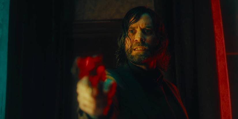 Alan Wake 2 pointing a gun to someone off camera