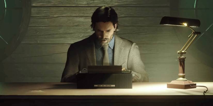 Alan Wake sitting at a typewriter in Alan Wake 2