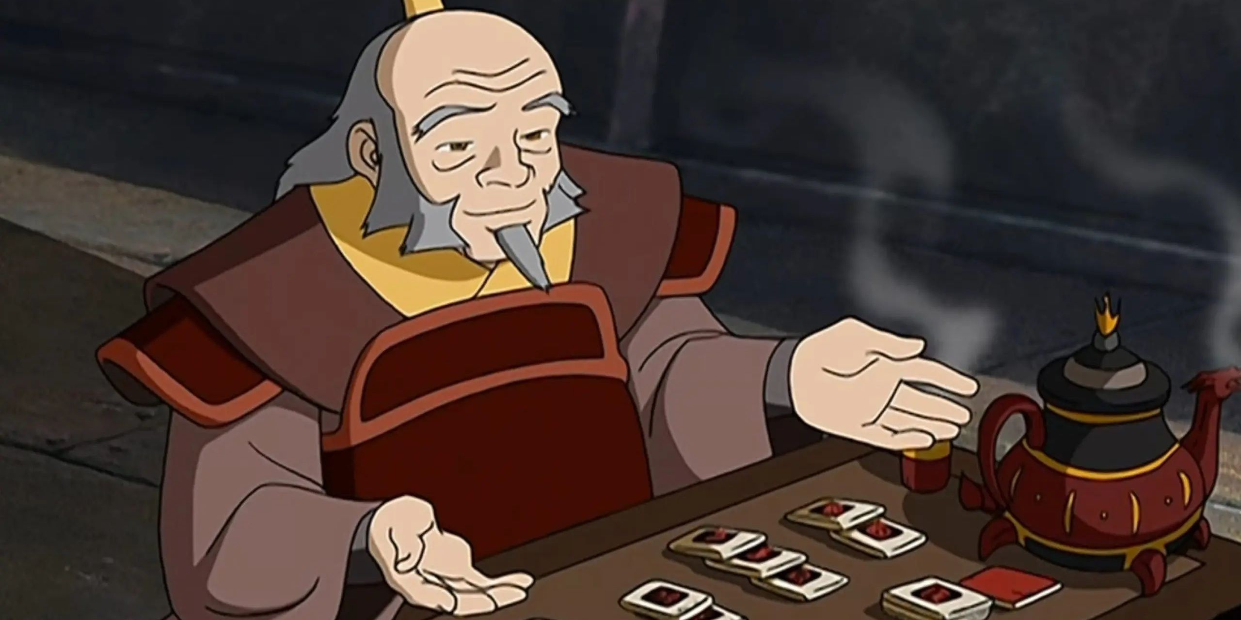 uncle iroh playing a game and drinking tea 