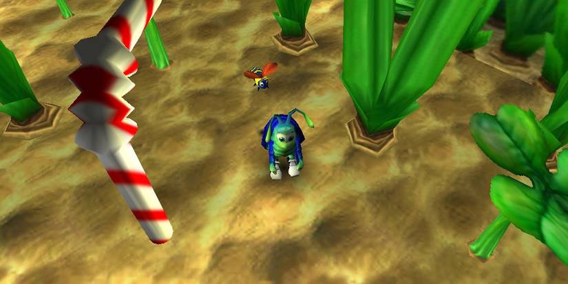 Overhead shot of Rollie McFly and a bee among tall grass. A bendy straw with a spiral red line is to the left.