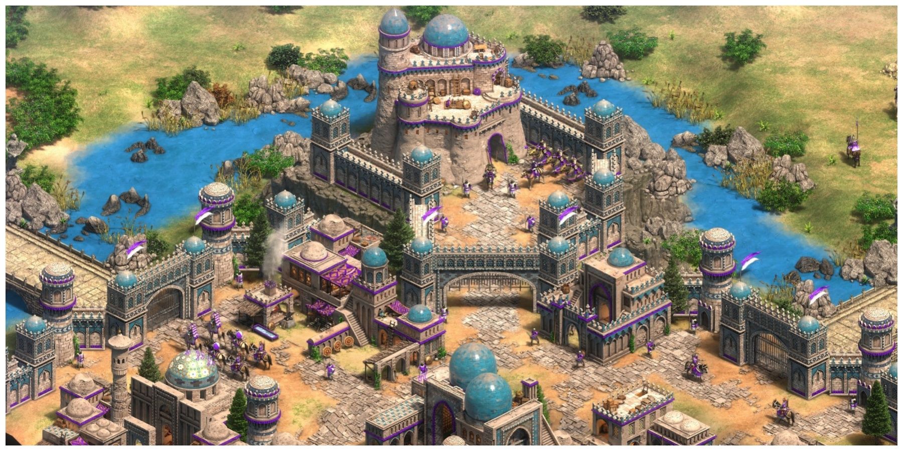 A huge castle in Age Of Empires 2 with villagers walking around it