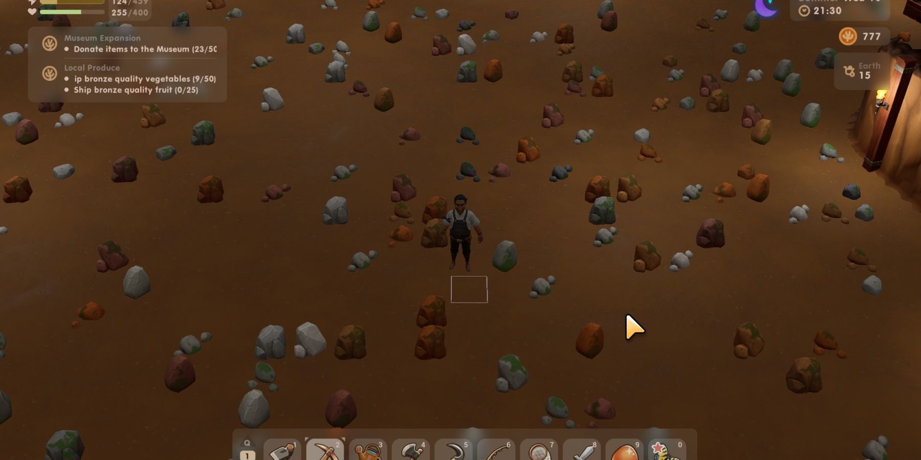 The player standing in the mines surrounded by rocks in Coral Island