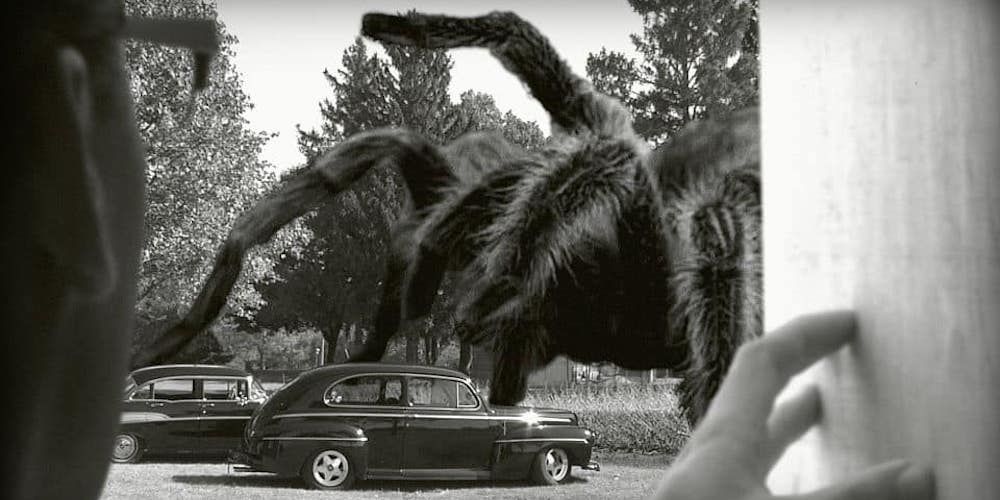 Giant spider walking through a street