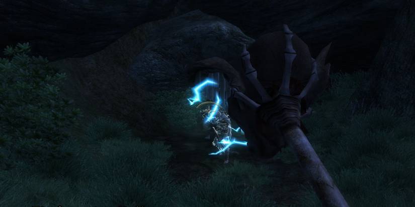 A totem zapping enemy goblins outside a cave at night