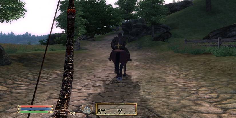 A player wielding a summoned Bound Bow behind a Imperial Legion guard on a horse in the countryside