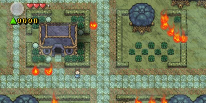 Kakariko Village on fire, with a woman standing outside a rectangle home and fire spread around the fields