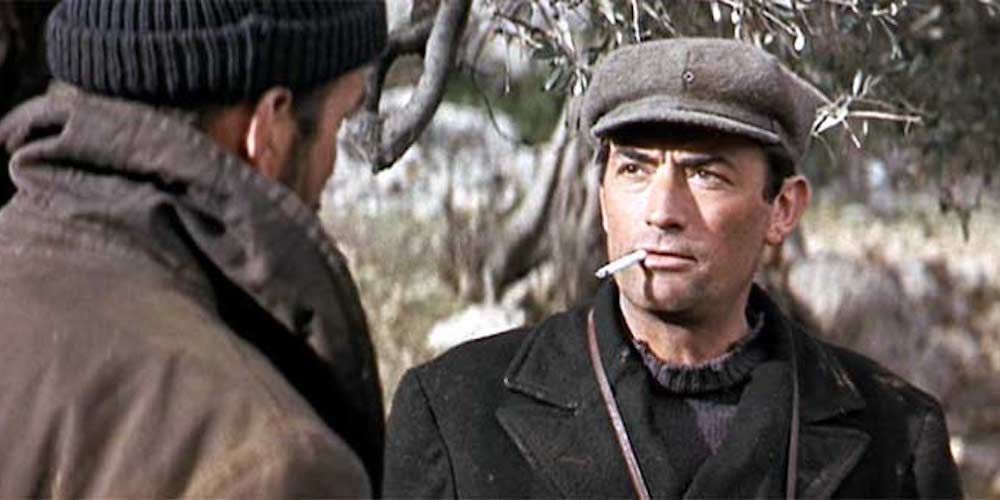 Gregory Peck looking at character with a cigarette in his mouth