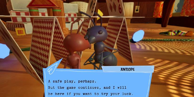 The game's ant protagonist talking to the black ant Antiope next to a tower of cards in a living room. The text from Antiope reads: "A safe play, perhaps. But the game continues, and I will be here if you want to try your luck."