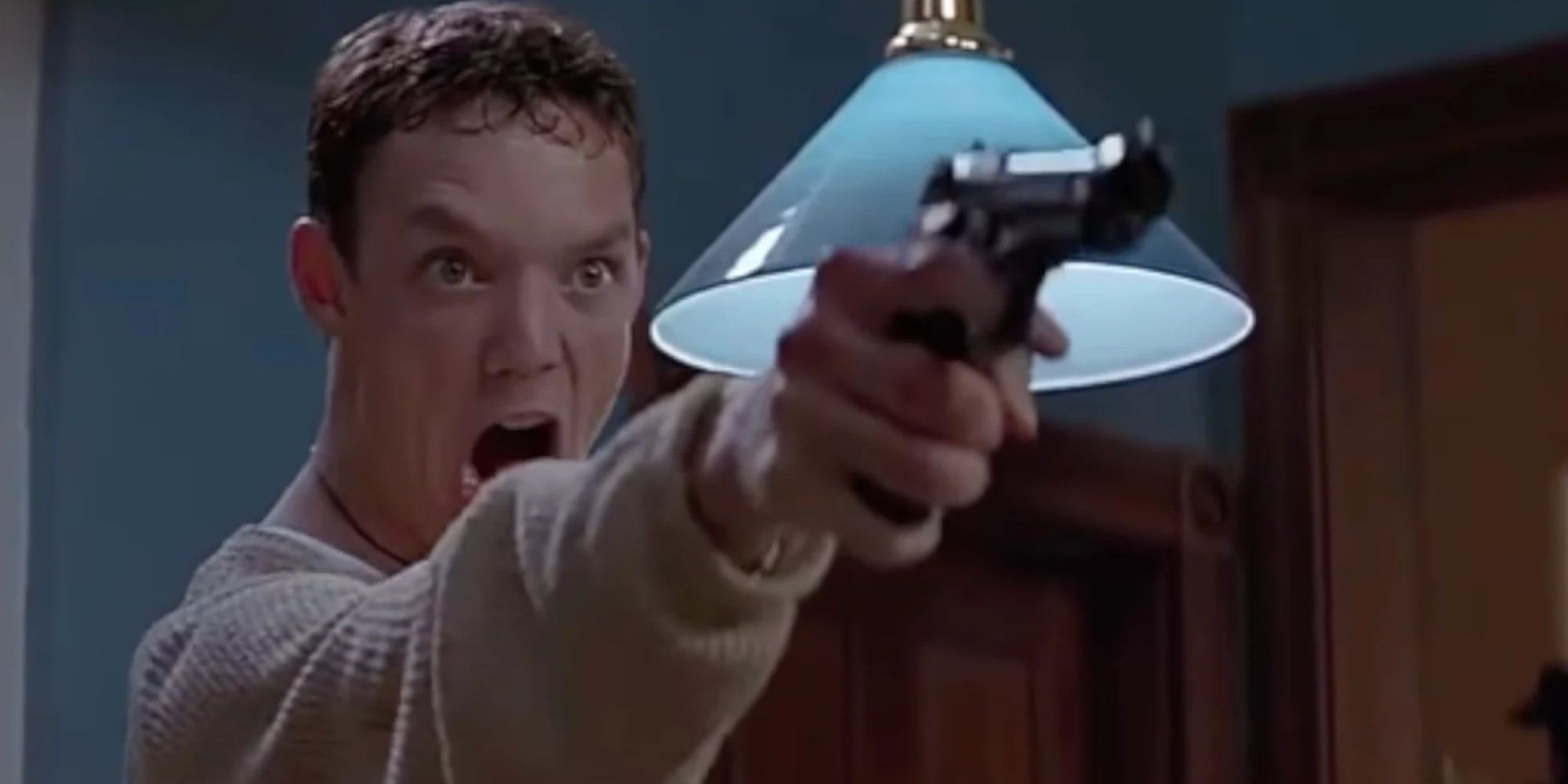 Stu Macher pointing a gun