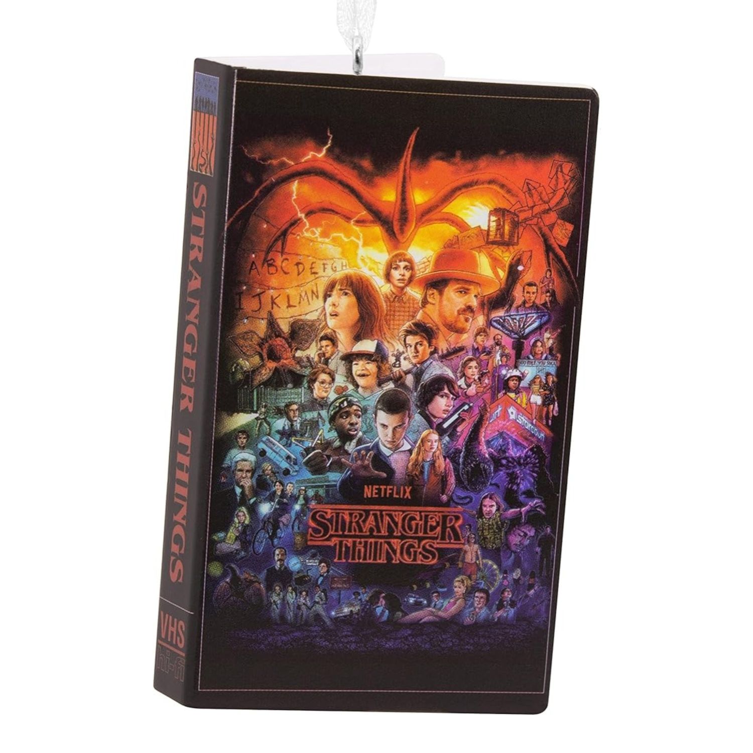 This ornament is of a VHS tape box with the cast of Stranger Things printed on it