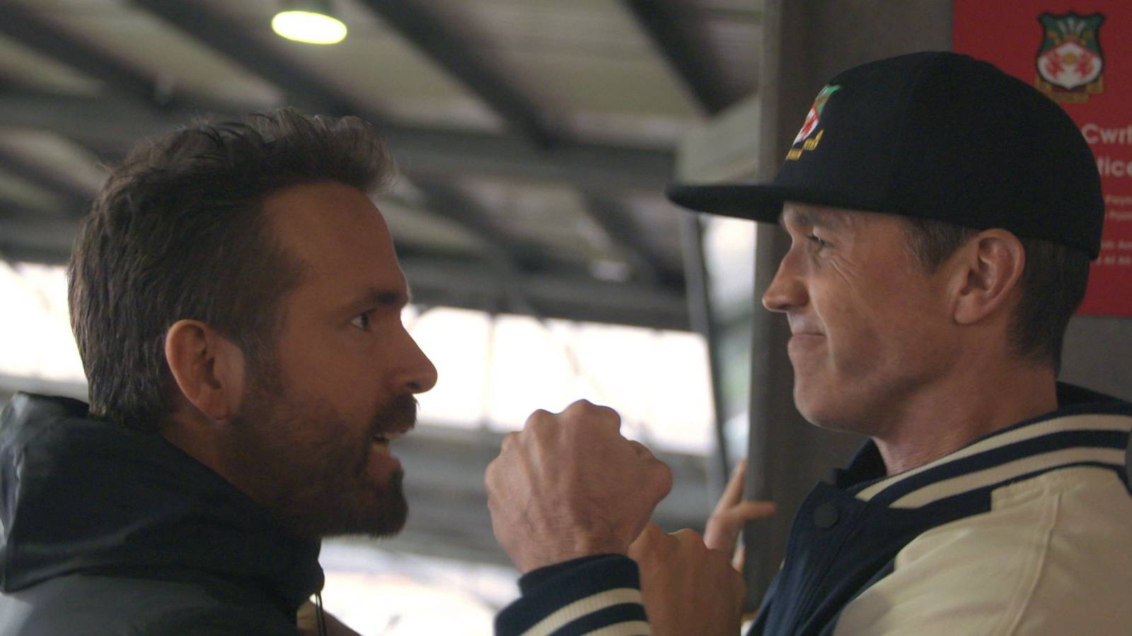 Ryan Reynolds and Rob McElhenney side photo celebrating Wrexham promotion.