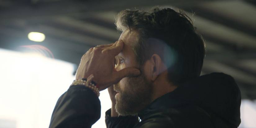 Ryan Reynolds profile photo shocked and thinking in Wrexham stands.