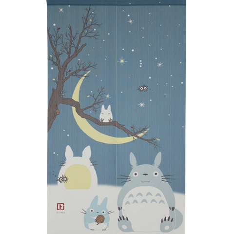 A long tapestry with Totoro creatures against a night sky