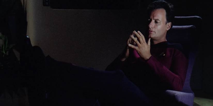 Q sits down in the episode "Q Who".