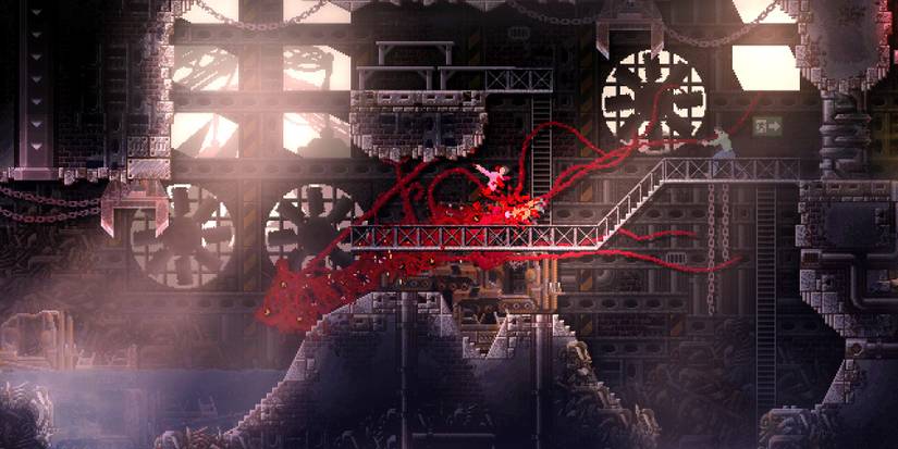 The monster in Carrion storming through industrial stage terrorizing small worker