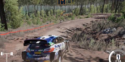 A rally car drifting around a corner on a dirt path in WRC 10