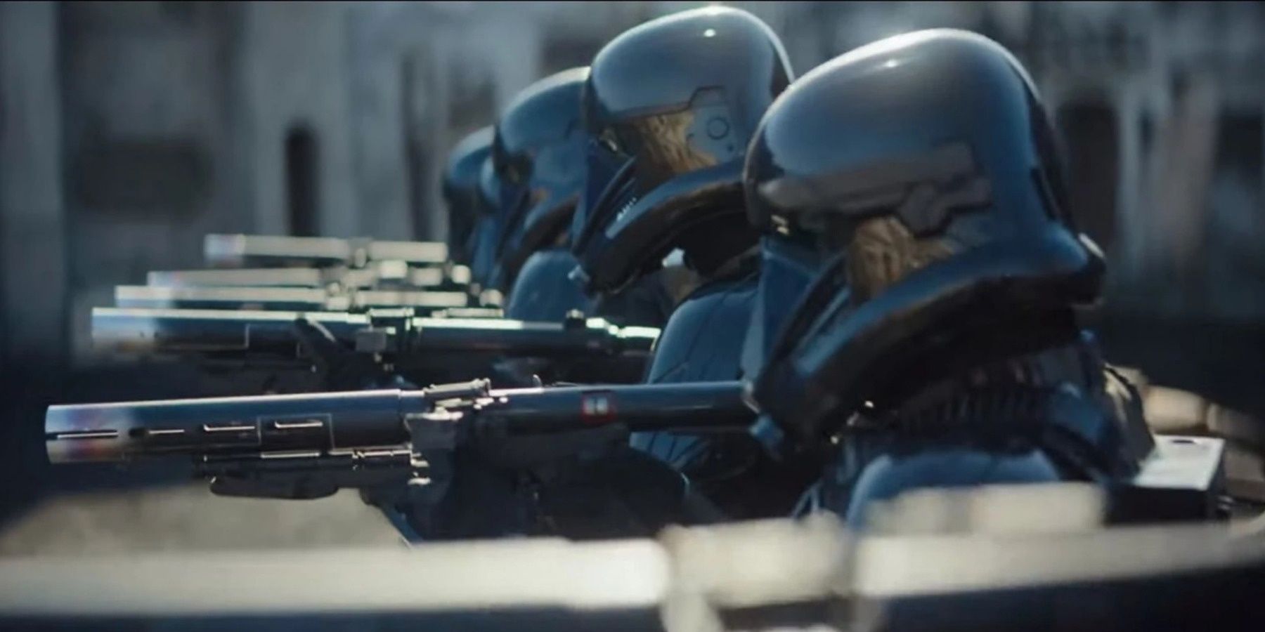 Death Trooper from The Mandalorian stand in a line with their blasters aimed