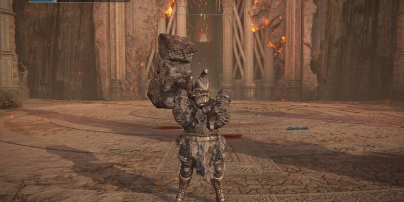 Elden Ring player wielding giant hammer in a courtyard