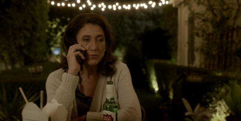 grace billets with a beer, on the phone