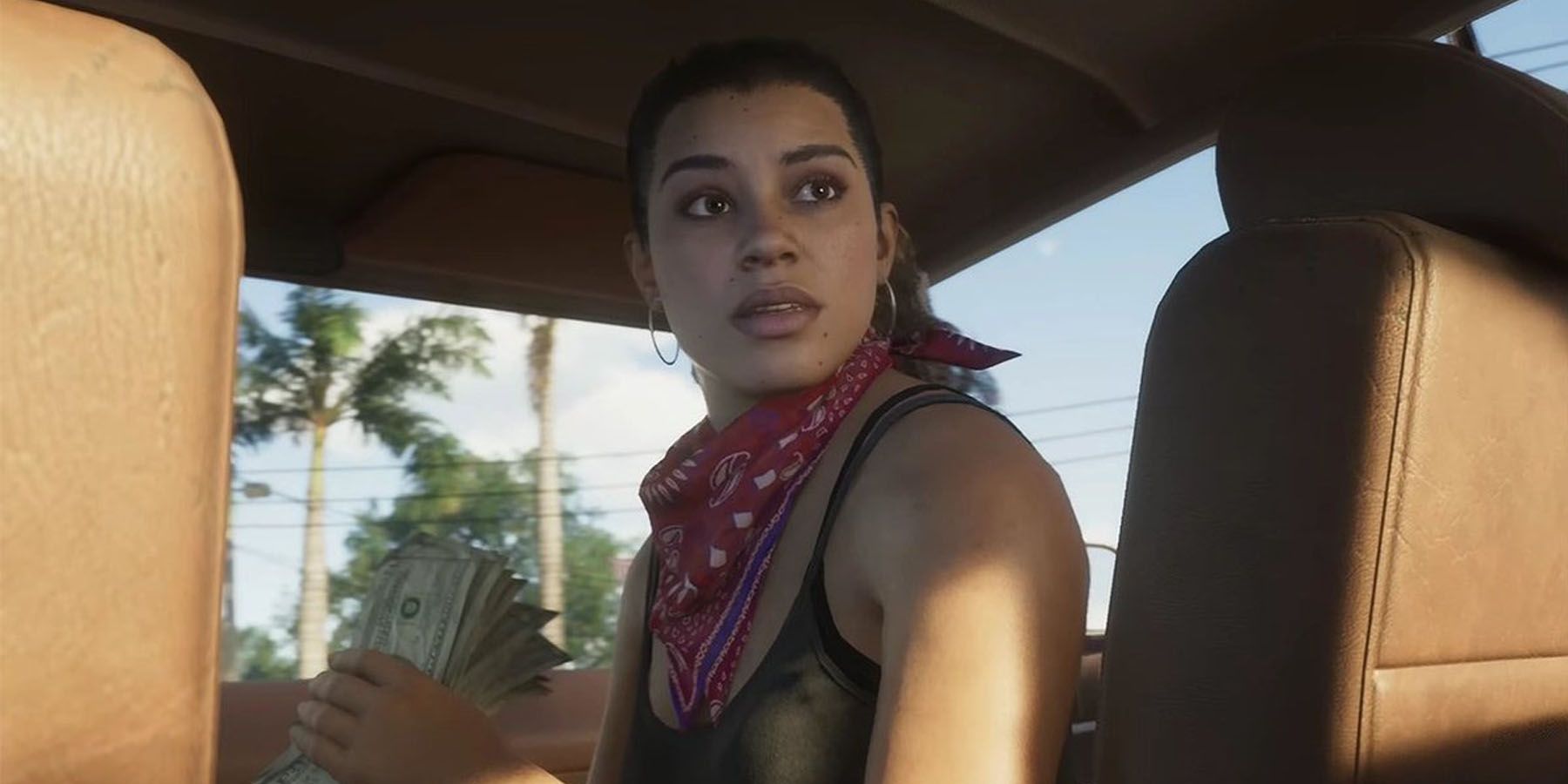 A screenshot of Lucia riding in the passenger seat of a car in Grand Theft Auto 6.