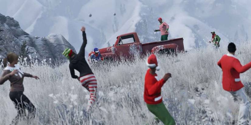 A screenshot of Grand Theft Auto Online players engaging in a holiday snowball fight.