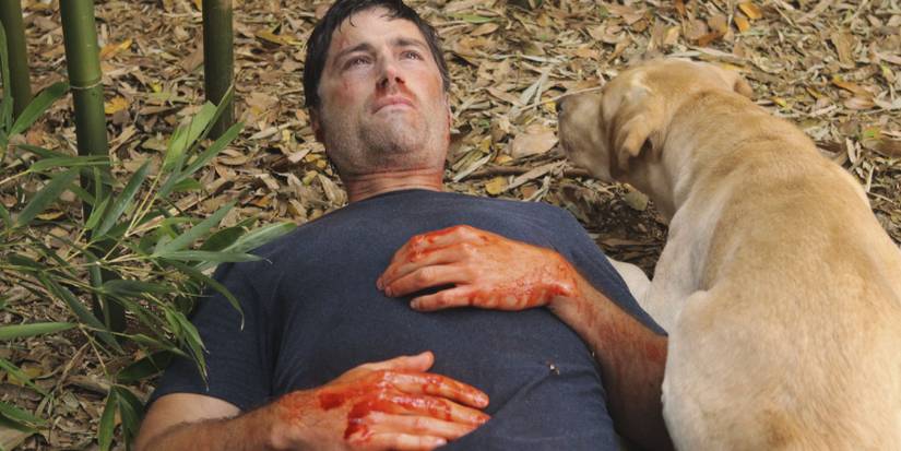 Matthew Fox as Jack Shepherd bleeding and laying next to a dog