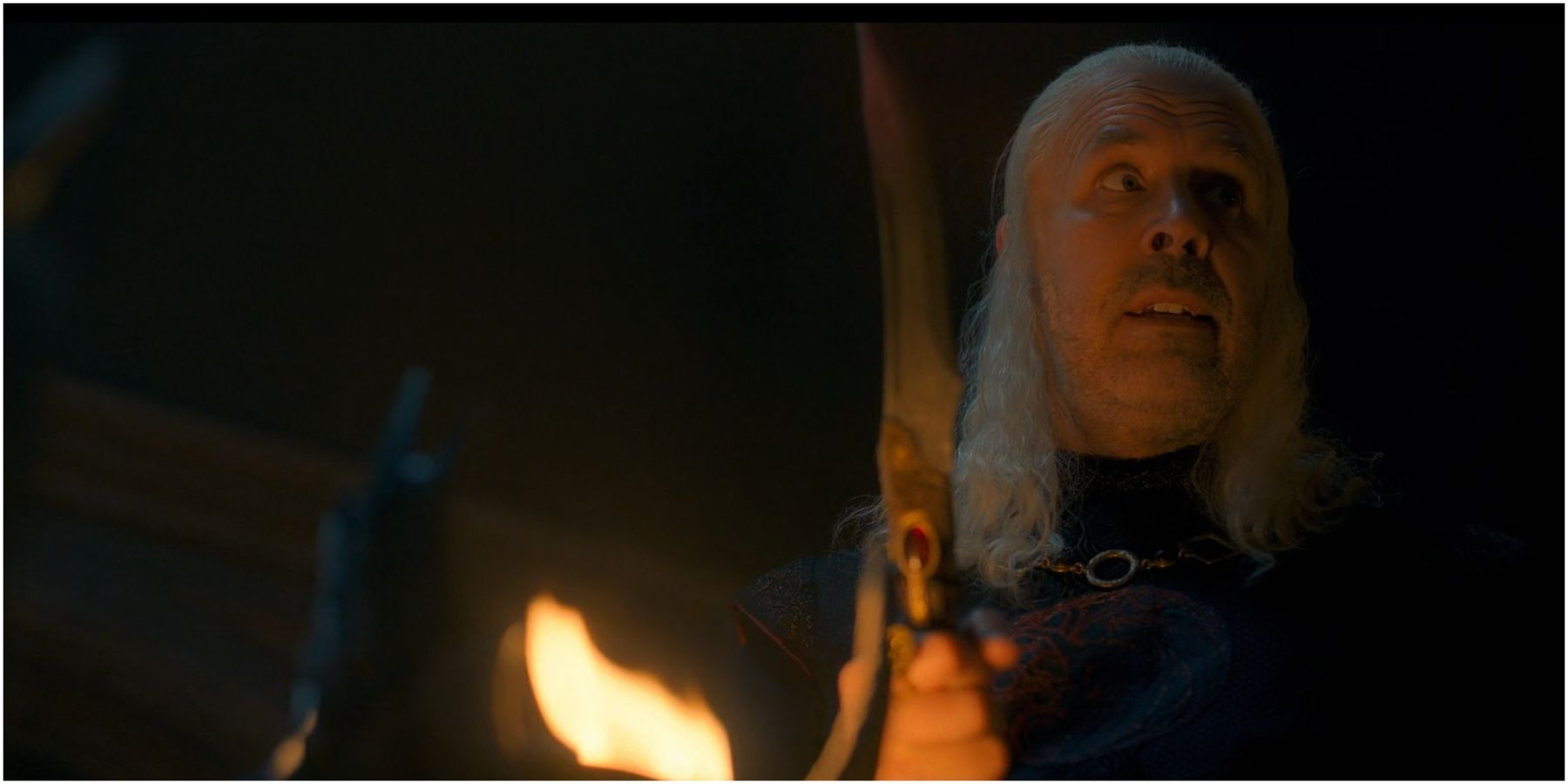 Viserys holds the Valyrian Steel dagger in House of the Dragon.