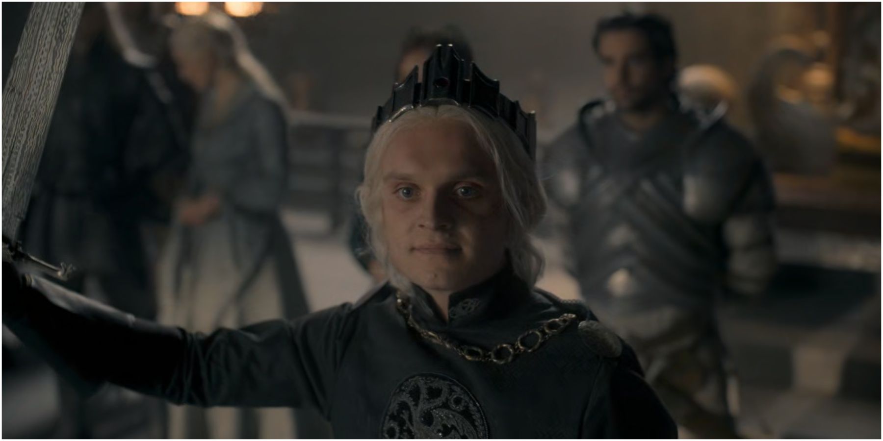 Aegon II Targaryen holds Blackfyre and wears the Conqueror's crown in House of the Dragon.