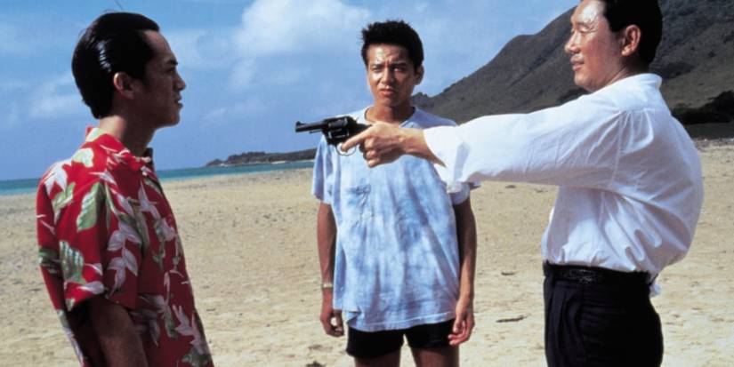 Man pointing a gun at another