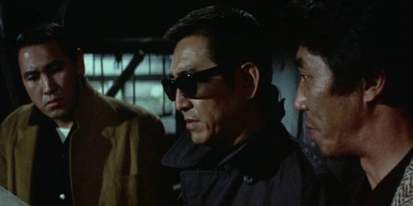 Three men looking at something important