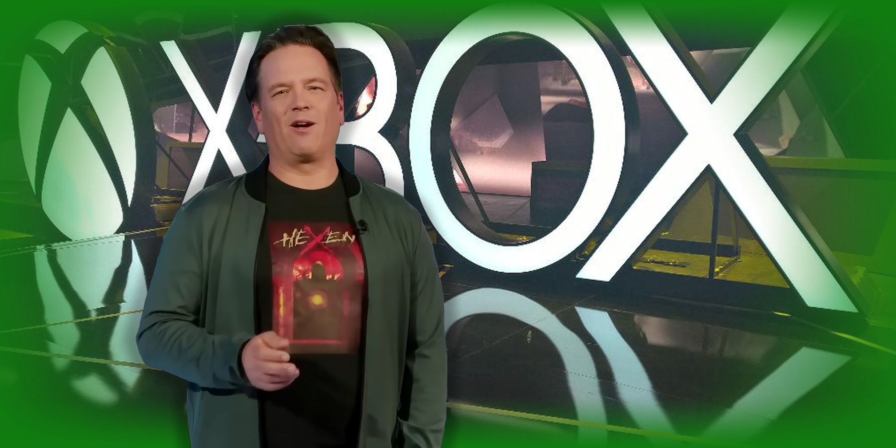 phil spencer in front of xbox logo