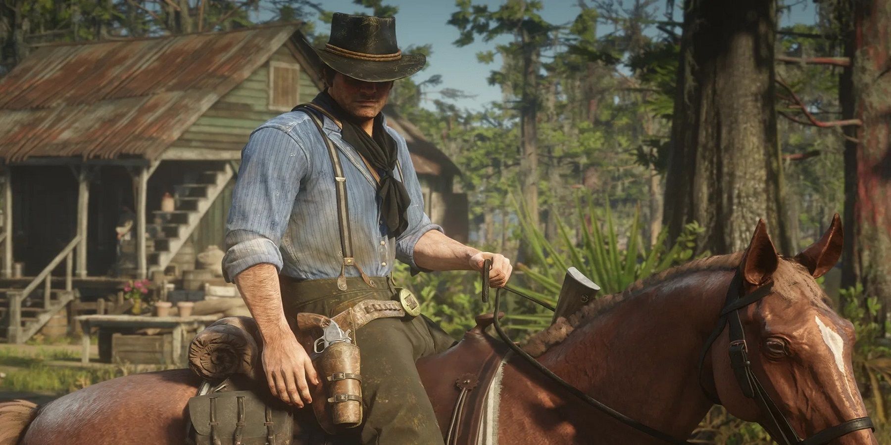 arthur morgan sits on a horse in red dead redemption 2