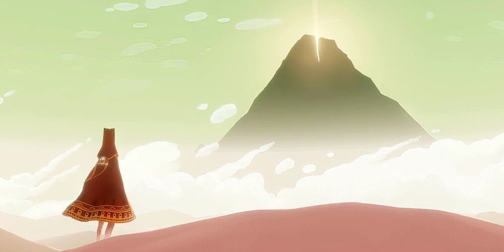 Traveller looking at a glowing mountain in Journey