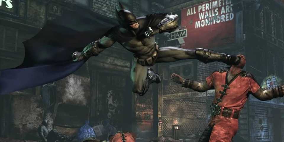 Batman kicking a thug in the face in Batman: Arkham City