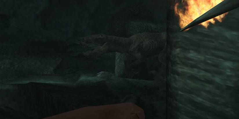 Player aiming a flaming spear at a T-Rex 
