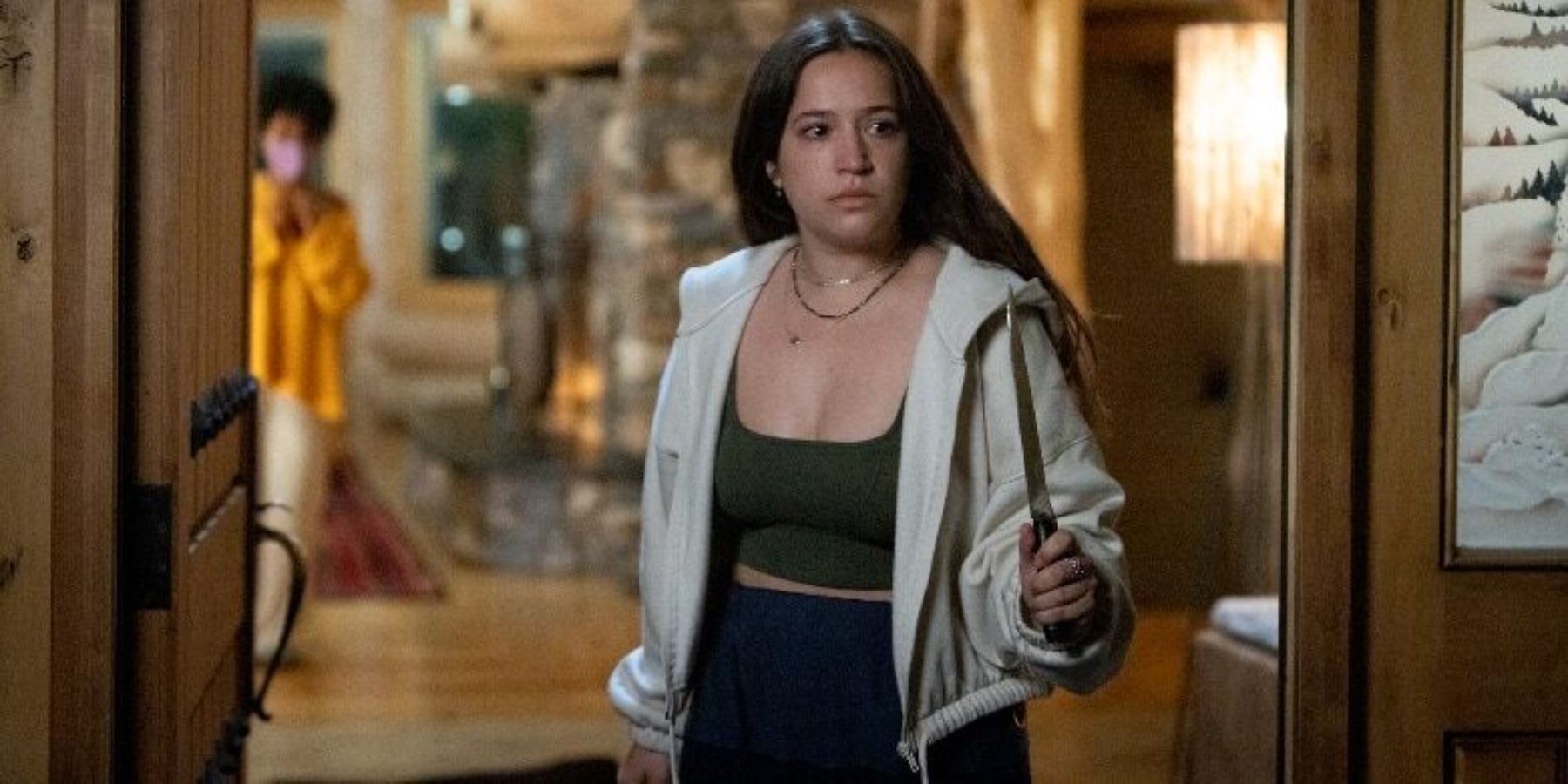 Gideon Adlon as Parker standing in a doorway of a house with Beth Million as Miri behind her in the movie Sick