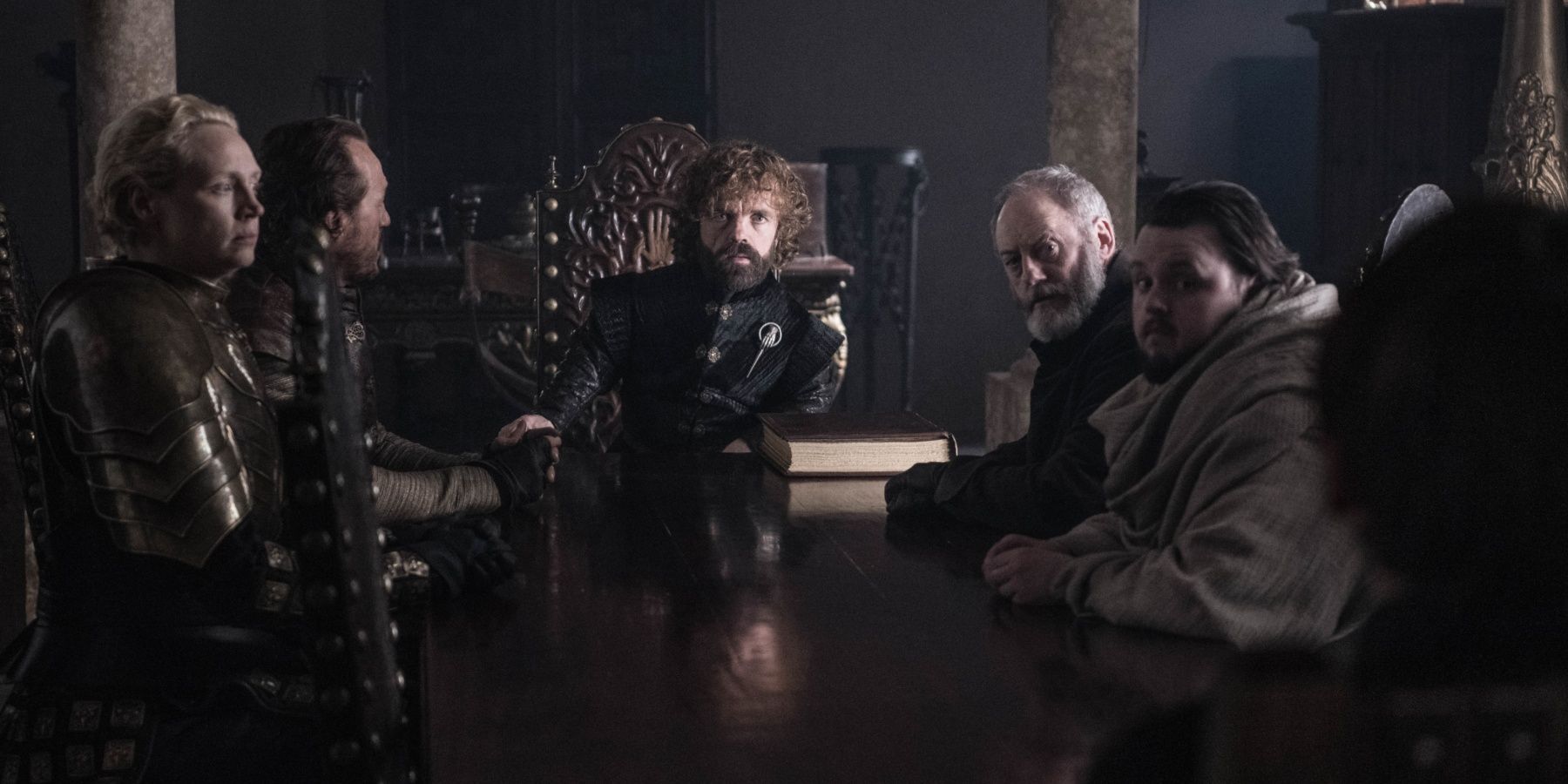 Tyrion sits at the head of the King's Small Council with Bronn, Brienne, Sam, and Davos